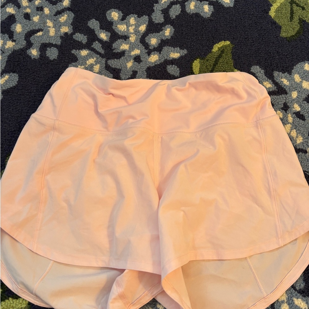 LIGHT PINK LULULEMON SPEED UPS INSEAM 4